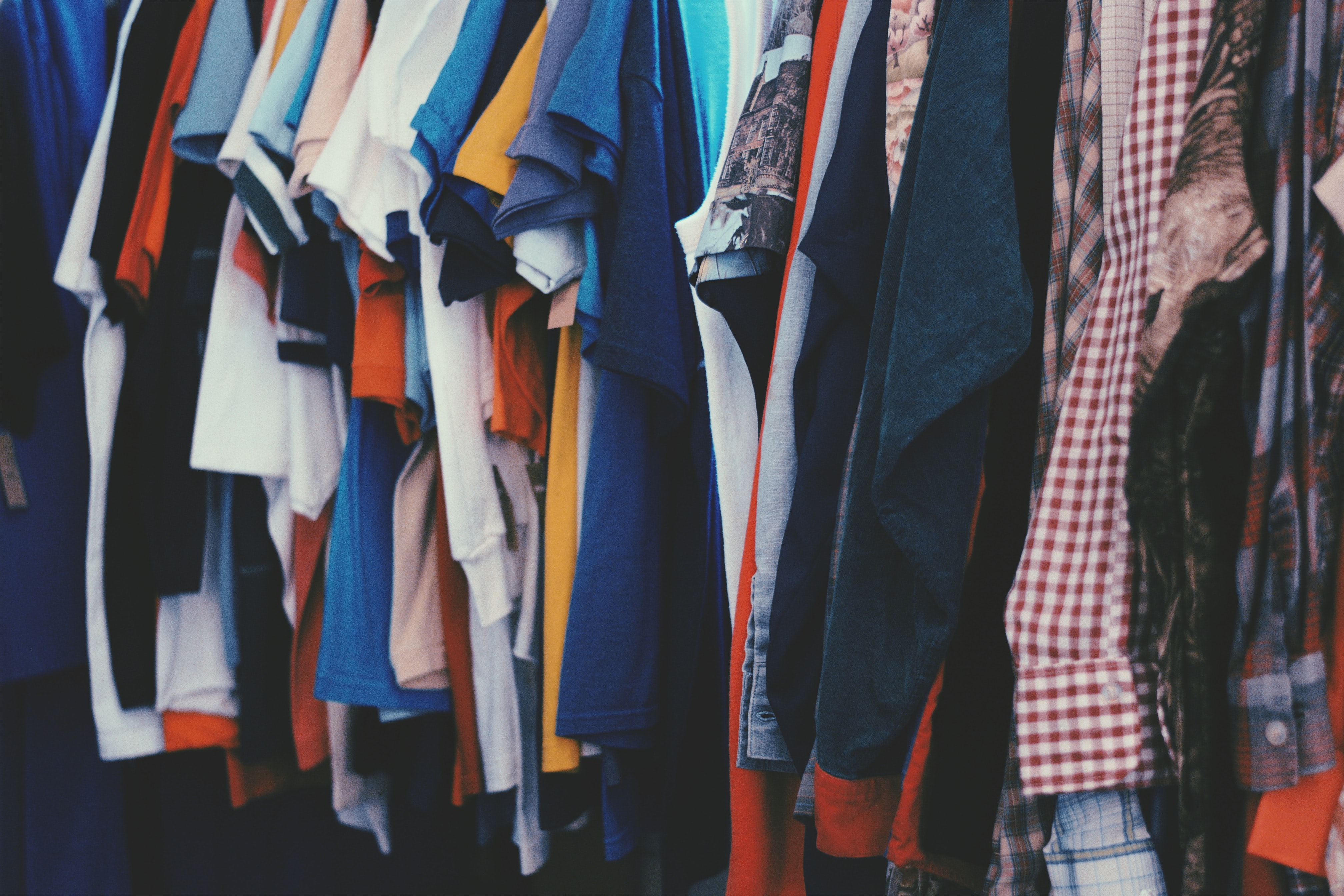 A rack full to the brim with clothing.